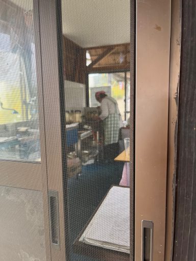 Ein Koch steht in einer kleinen Küche und bereitet Speisen vor.