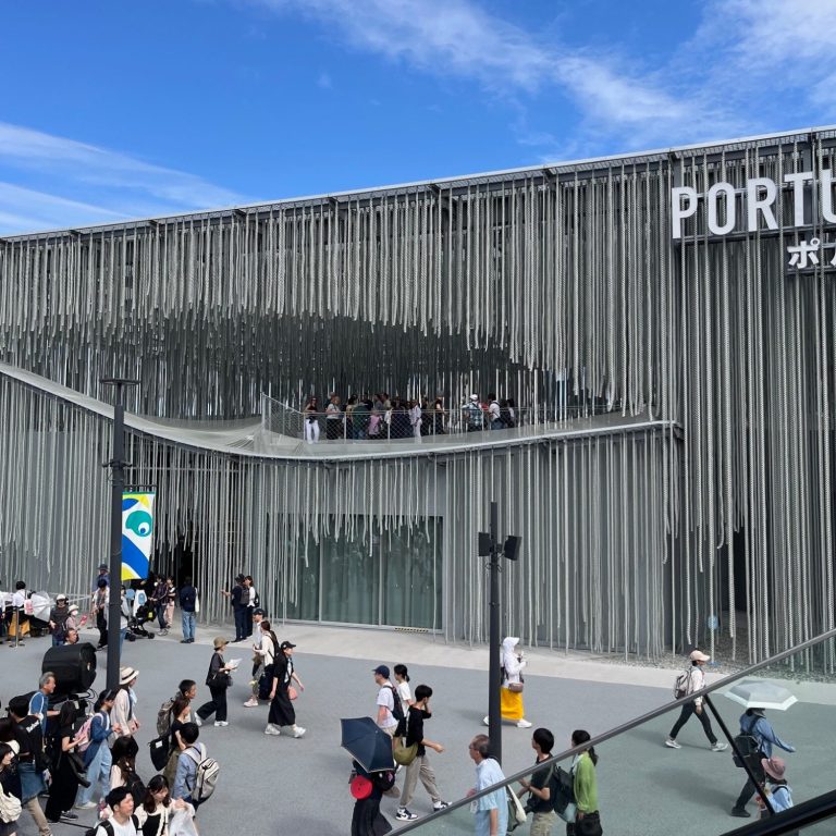 Moderne Gebäude mit hängenden Lamellen und Menschenmenge vor dem Eingang.